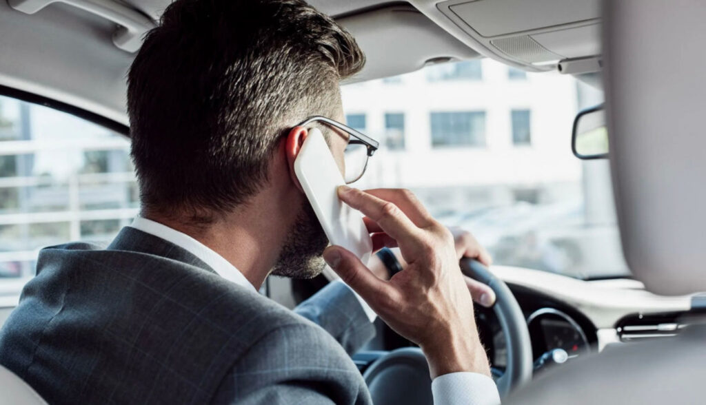 чоловік розмовляє по телефону в машині